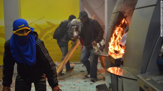 Masked protesters destroyed cash dispensers during the Rio protests on October 7.