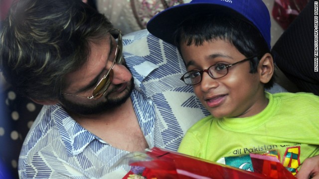 Former Pakistani cricket captain Shahid Afridi chats with a polio-afflicted child during a 'Make A Wish' event in Karachi 18 June, 2011. 