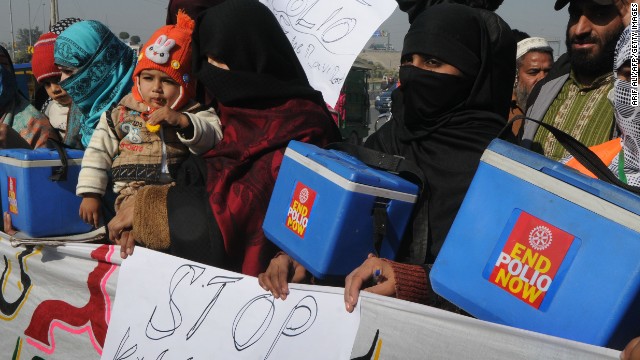 Pakistani polio vaccination workers carry placards during a protest against the killing of their colleagues in Lahore on December 21, 2012. 