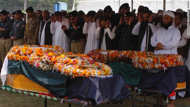 People attend funeral prayers for victims of an explosion in Peshawar, Pakistan, Monday, October 7, 2013. A bomb exploded next to a van carrying Pakistani security guards tasked with protecting workers involved in an anti-polio drive in the country's northwest on Monday.