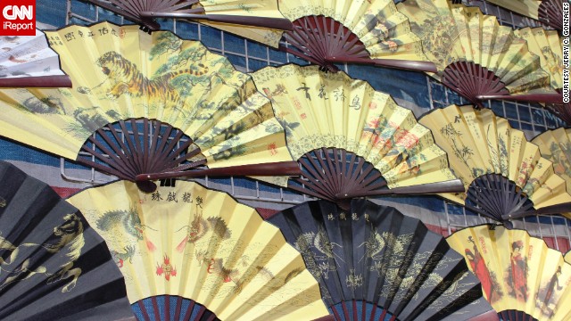 Handcrafted fans are some of the <a href='http://ireport.cnn.com/docs/DOC-776029'>many souvenirs</a> to be found in the street markets of Hong Kong's most crowded neighborhood.