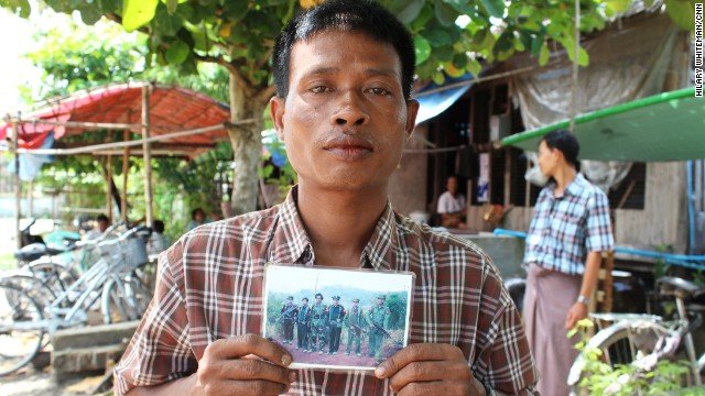 Soe Paing holds an image of his son Zaw Zaw Lin who was recruited while at a monastery in Yangon.