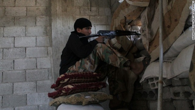 An opposition fighter from the Al-Ikhlas brigade guards a post in Deir Ezzor, Syria, on Wednesday, October 9. 