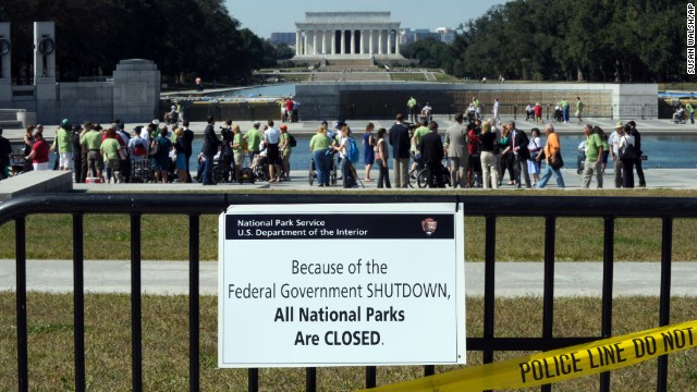 Despite signs stating that the national parks are closed, people visit the World War II Memorial in Washington on October 2.