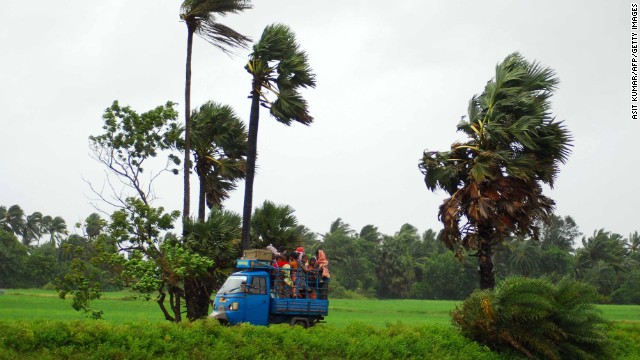 Evacuees travel in an auto rickshaw as they leave the Sanabandha village in India on October 12.