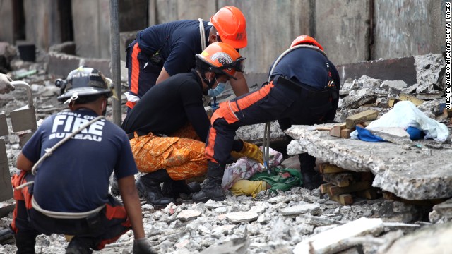 Rescuers pull a man from the rubble in Cebu on October 15.