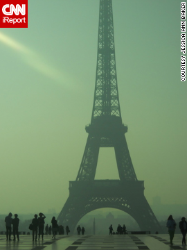 Tourists take in the Eiffel Tower on a <a href='http://ireport.cnn.com/docs/DOC-954301'>hazy spring day</a>. "There really is just something amazing about Paris in the springtime," said Jessica Ann Baker.