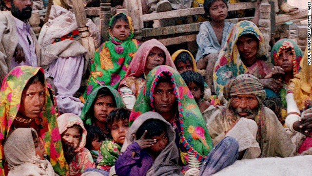 A group of Pakistani bonded laborers including women and children sit with their belongings after their release in a village Kahpro, some 280 kilometers east of Karachi. The country, with large populations of displaced people and weak rule of law, has an estimated 2.2 million slaves.