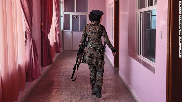 A female member of Yemen's elite counterterrorsim unit checks the barracks, in this photo from Stephanie Sinclair.