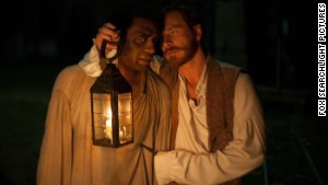 Chiwetel Ejiofor, left, stars as Solomon Northup and Michael Fassbender stars as Edwin Epps in \