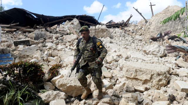 A Philippine soldier walks through the ruins of the historic Holy Cross Parish Church in Maribojoc on October 18.