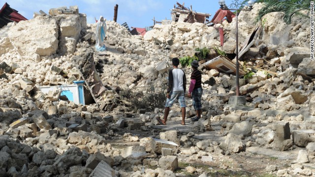 Residents view the ruins of the historic Holy Cross Parish Church in Maribojoc on the central Philippine island of Bohol on Friday, October 18. The death toll has risen above 180 after a magnitude-7.1 earthquake on October 15.