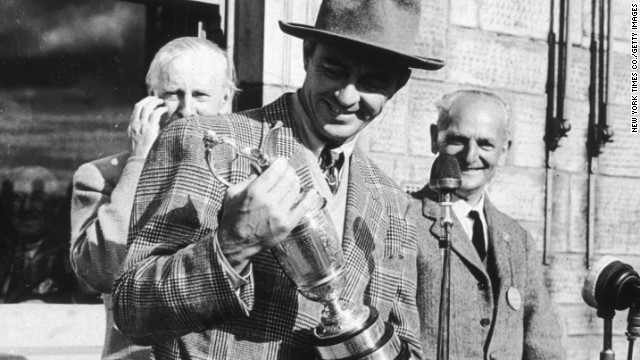 The late American golfer Sam Snead holds the 1946 British Open Golf Championship trophy in St. Andrews, Scotland. His family sold the claret jug he won at the open this year for $262,900. His relatives are not alone. Many retired big-name athletes are cashing in by selling their sports memorabilia.