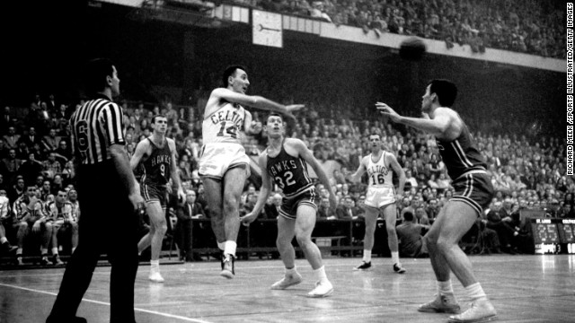 Boston Celtics great Bob Cousy makes a pass against the St. Louis Hawks in 1957. Cousy sold just about all the uniforms and memorabilia in his basement for around $320,000, which he gave to his two daughters, says Bob Greene. 