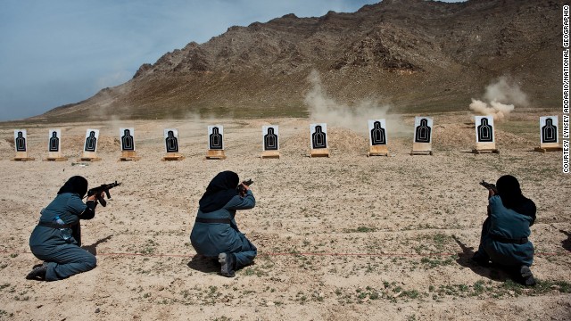 Women—mostly widows—train for police force jobs at a firing range near Kabul, in this image by Lynsey Addario. The female officers can take on tasks that men cannot because of Islamic custom: frisking other women, searching homes where female family members are present. 