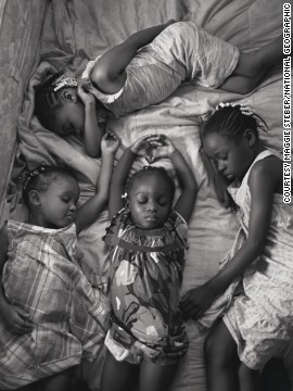 Photographer Maggie Steber took this photo of four young sisters in Miami, Florida, napping on a Sunday afternoon after attending church, as part of a feature on sleep. 