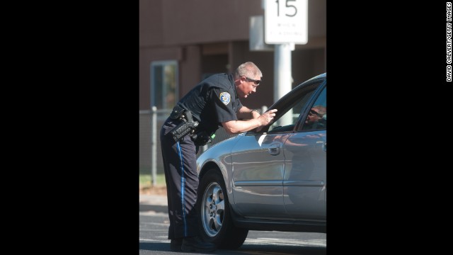 A police officer stops traffic near Agnes Risley Elementary.