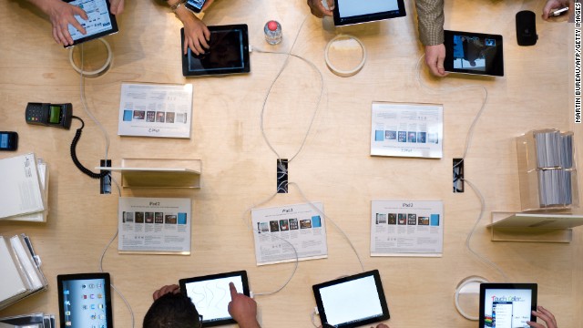 Customers play with iPad 2s at the Apple store in Paris's historic Opera district on March 25, 2011, the day the device went on sale in 25 countries. The second generation of the tablet added two cameras.