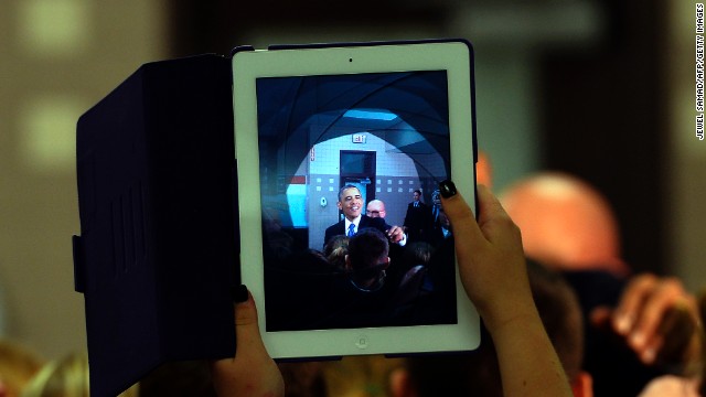 A student uses her iPad to take a picture of President Barack Obama as he greets students at a middle school in Mooresville, North Carolina, on June 6, 2013. 