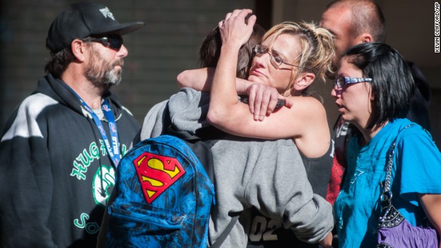 A Sparks Middle School student cries with family members.