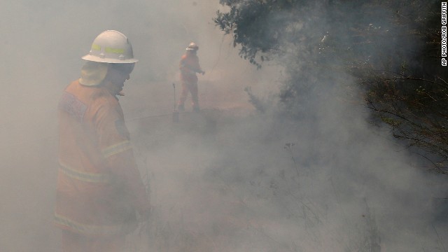 Smoke fills the air along the roadside as fires threaten homes in the Blue Mountains on Tuesday, October 22.