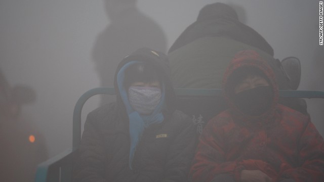 Local residents in the northeastern city of Harbin brave the thick smog on October 21.