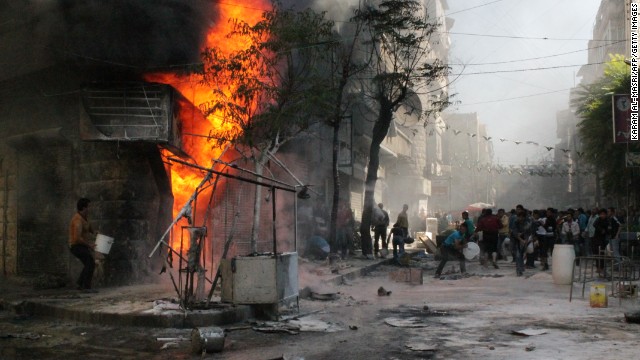 People use buckets as they try to extinguish a fire that ignited at a fuel station in Aleppo, Syria, on Sunday, October 20. 