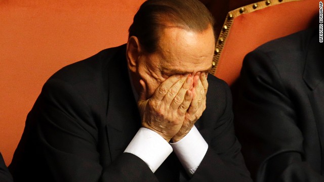 Berlusconi rubs his eyes after delivering a speech at the Senate in Rome on October 2.