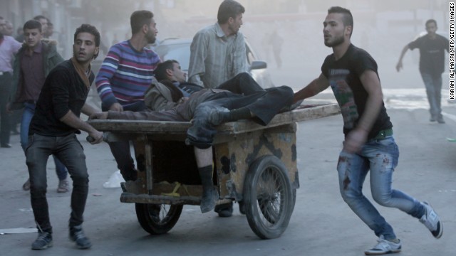 Two injured men are transported on a cart in Aleppo, Syria, following shelling as fighting between pro-government forces and rebels continues on Saturday, October 26. 