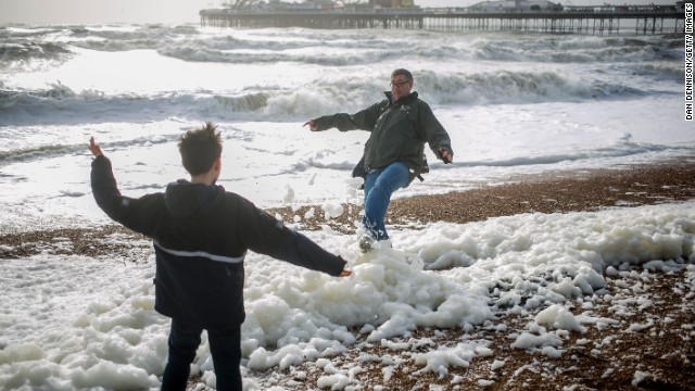 Father and son play on the beach in Brighton, England, on Sunday.