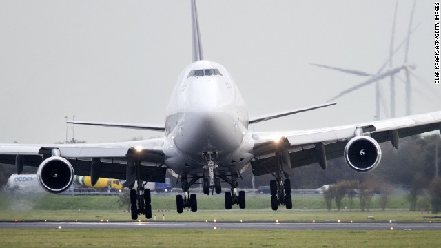 A plane lands with a tilted angle Monday on the runway of Amsterdam Schiphol Airport.