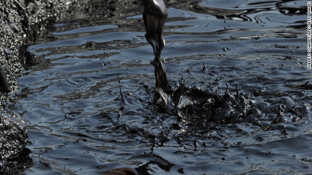 Tainted water pours into a containment pond in a Unity field processing facility in what is now South Sudan, where there are concerns about the environmental damage being caused by the oil industry.