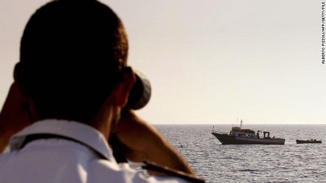 An Italian coast guard officer checks a Tunisian fishing boat in the Mediterranean.