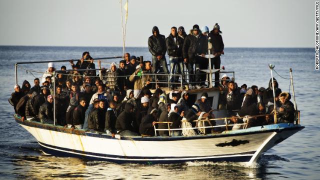 A boatfull of immigrants approaches the island in March 2011.