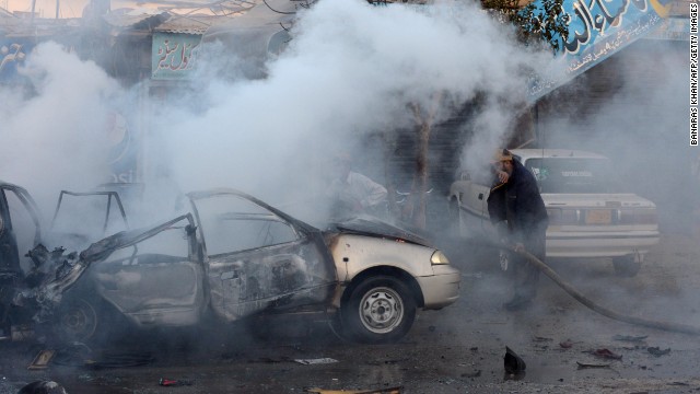 A Pakistani firefighter extinguishes burning vehicles after a bicycle bomb explosion in Quetta on October 30.