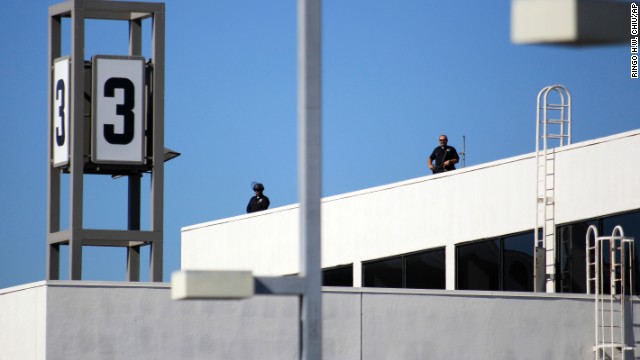 Police officers stand guard atop Terminal 3.