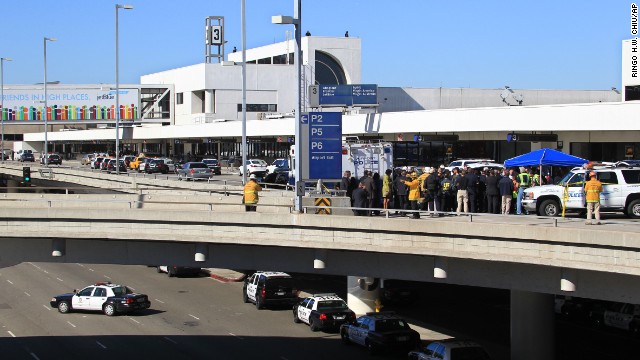 Police officers and emergency response officials meet outside Terminal 3 at Los Angeles International Airport after <a href='http://www.cnn.com/2013/11/01/us/lax-gunfire/index.html'>gunshots were reported</a> inside the terminal on Friday, November 1.