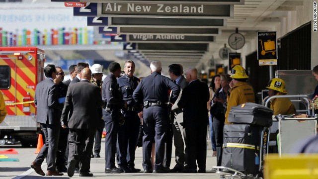 Los Angeles Police Chief Charlie Beck talks with other responders at the airport Friday.