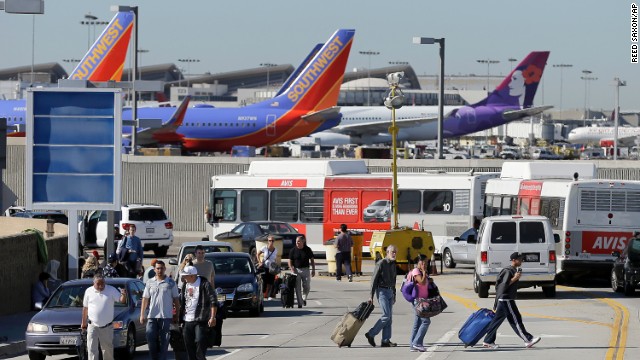 Passengers evacuate the airport after the incident, which airport officials said began about 9:30 a.m. The gunfire and the airport's announcement of the incident provoked chaos among travelers, passengers said.