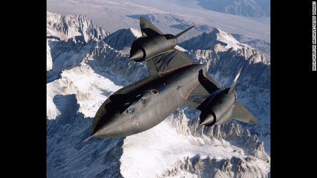 An SR-71B Blackbird flies over snow-capped mountains in 1995. 