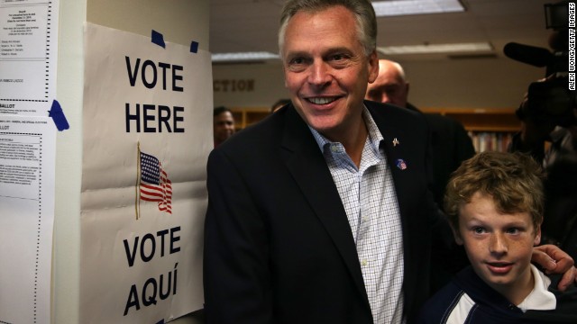 Terry McAuliffe and his son Peter leave a polling station Tuesday after he cast his vote.