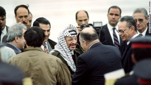 Arafat is greeted by Tunisian Defense Minister Abdelaziz Ben Dhia upon his arrival at the Tunis airport on April 10, 1992. Days earlier, Arafat survived a plane crash over the Libyan desert that killed the pilot and two others.