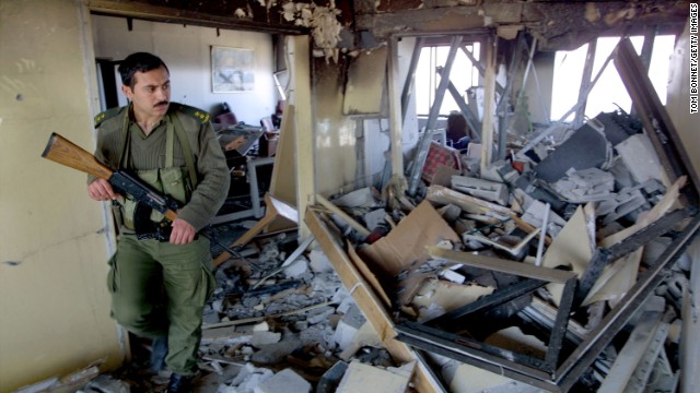 A Palestinian security officer inspects damage to Arafat's seaside office in Gaza City on March 10, 2002. Israeli helicopters attacked the compound hours after an Islamic suicide bombing in Jerusalem.