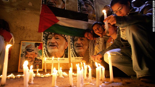 Palestinians hold a candlelight vigil for an ailing Arafat in Ramallah on November 10, 2004. A top aide said Arafat suffered a brain hemorrhage.