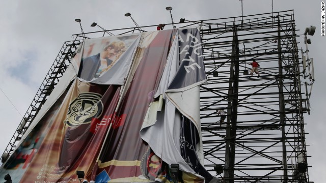 Workers bring down a billboard in Makati, Philippines, on November 7 before Haiyan makes landfall.