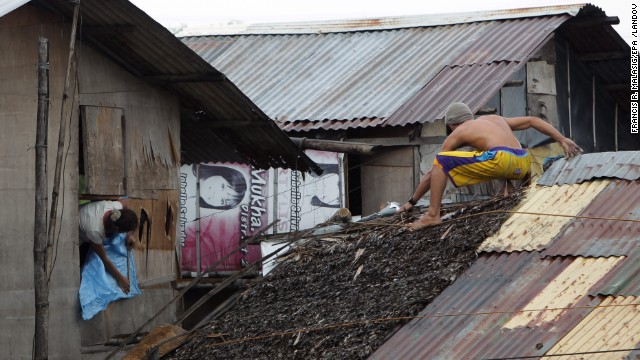 Residents reinforce their homes in Las Pinas on November 8.