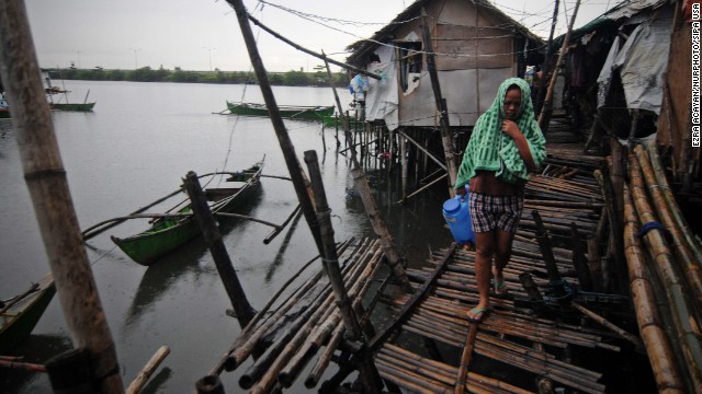 A resident walks along a fishing village in Bacoor, Philippines, on November 8.