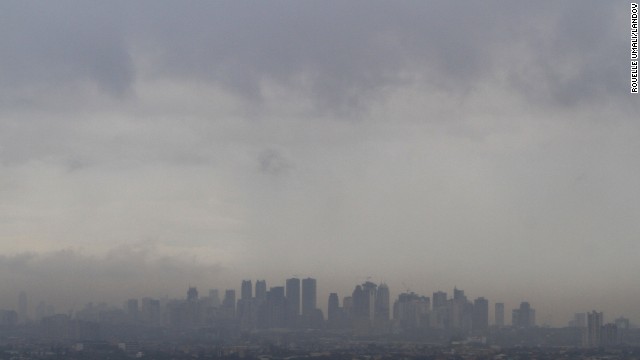 Dark clouds brought by Haiyan loom over Manila skyscrapers on November 8.