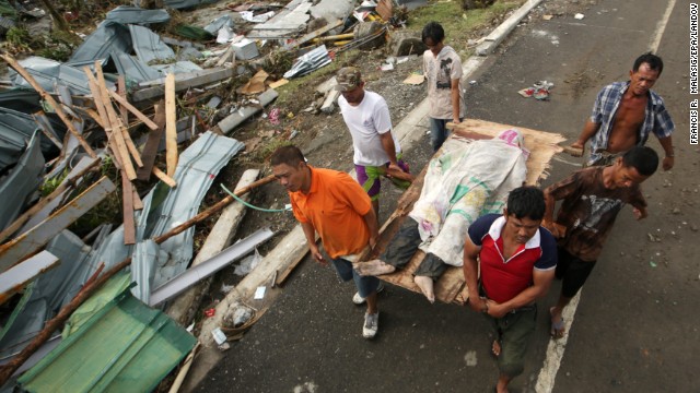 People carry a victim of the typhoon in Tacloban.