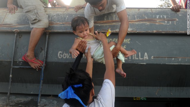 Residents return to their houses after leaving an evacuation site in Tacloban. 